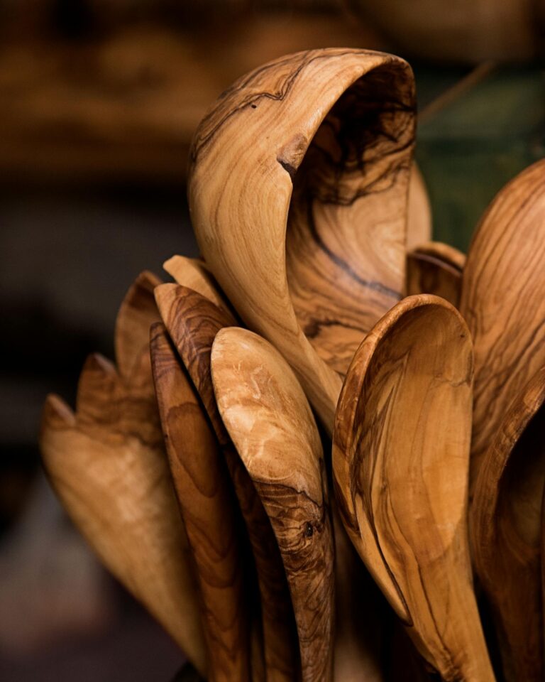 A detailed close-up of rustic wooden spoons showcasing their natural grain pattern and craftsmanship.
