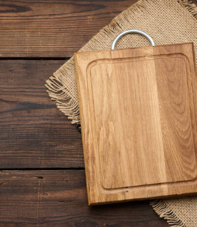 Empty rectangular wooden cutting kitchen board on table, top view