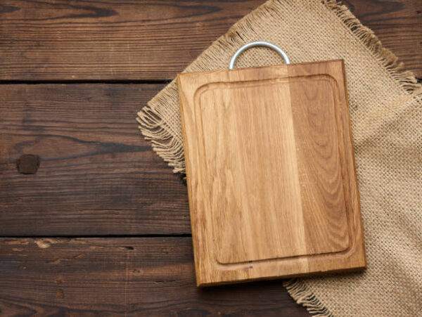 Empty rectangular wooden cutting kitchen board on table, top view