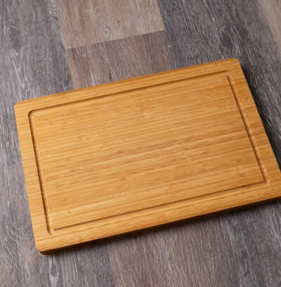 Empty cutting board on a wooden table, close up, copy space for text.