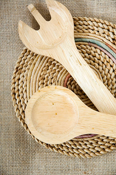 Spoon and fork on mat in natural style