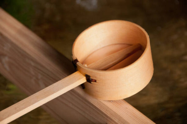 Wooden dipper of holy zen water in japan shinto temple