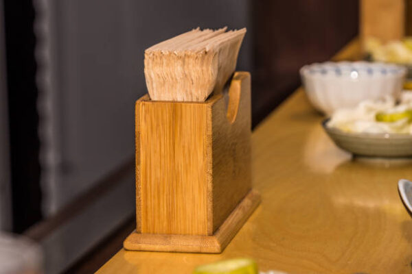 Tissue paper in the elegant yellow bamboo holder in the restaurant